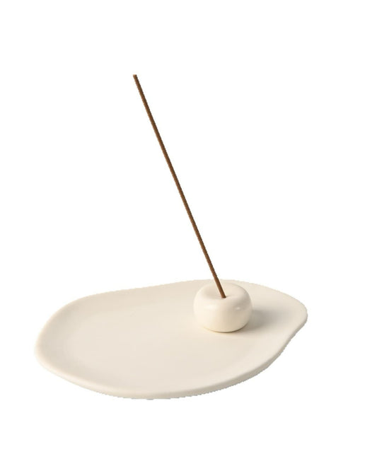 River Stone ceramic incense set on a white background: an unglazed tray with a small glazed stone holding a lit incense stick upright