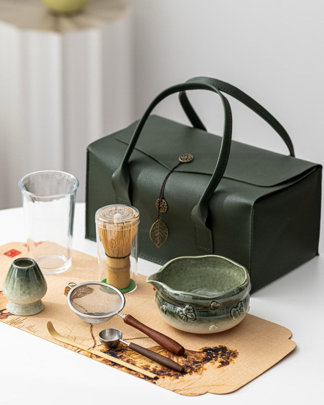 Pink and green ceramic matcha bowl set with bamboo whisk and carrying case