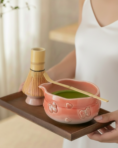 Sakura Pink matcha bowl and bamboo whisk on a wooden tray