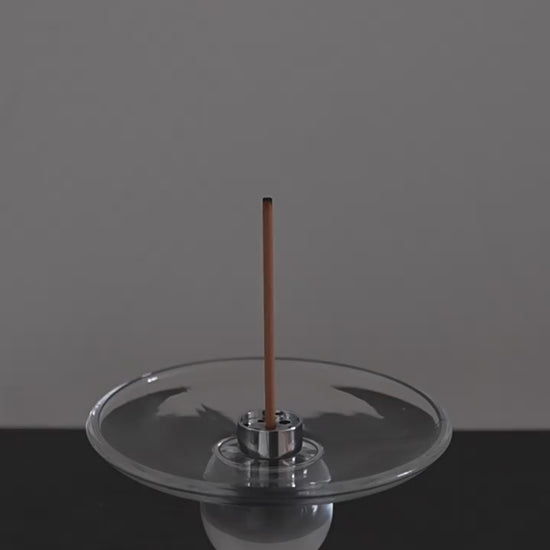 Lighting an incense stick and setting it into the steel insert of the Clear Hour glass holder