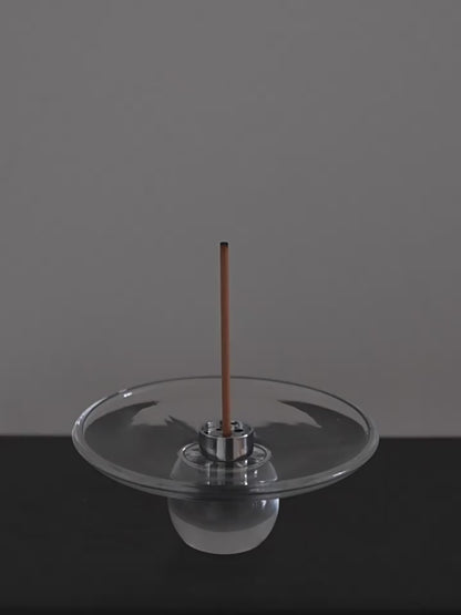 Lighting an incense stick and setting it into the steel insert of the Clear Hour glass holder
