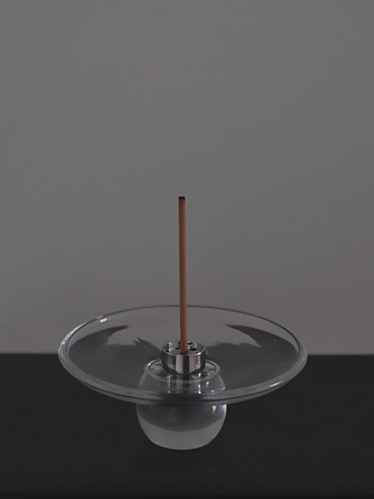 Lighting an incense stick and setting it into the steel insert of the Clear Hour glass holder