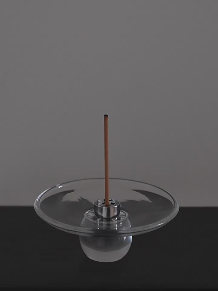 Lighting an incense stick and setting it into the steel insert of the Clear Hour glass holder